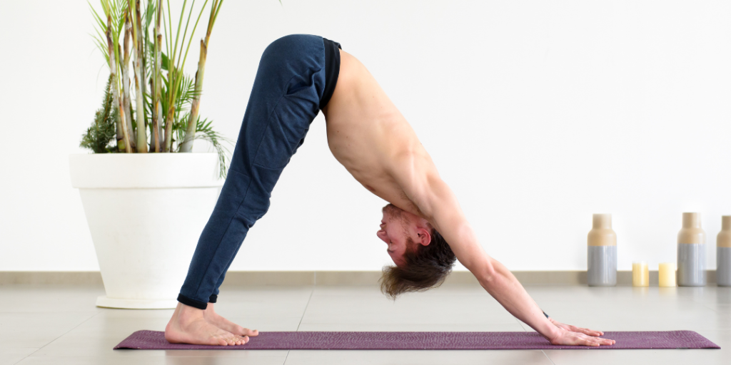 Benefits of Yoga for men. A man doing downward dog pose