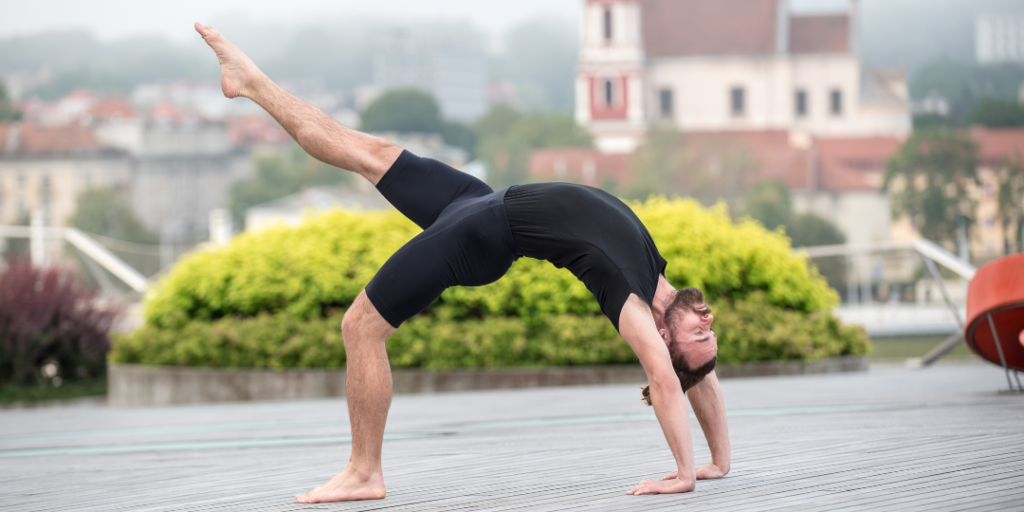 Benefits of Yoga for men. A man doing wheel pose