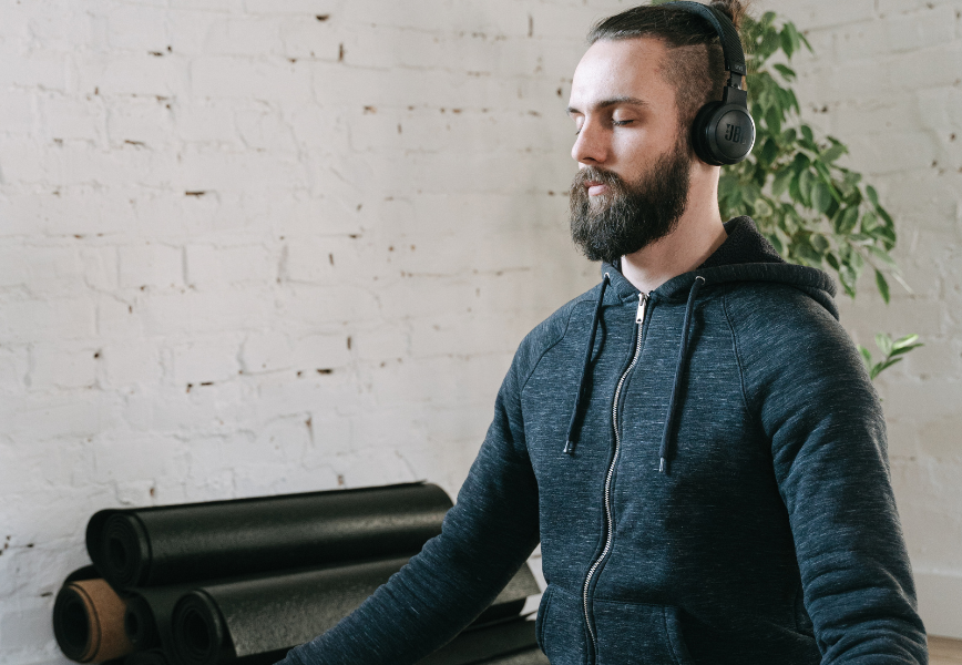 How to meditate for anxiety. A man wearing a headset meditating