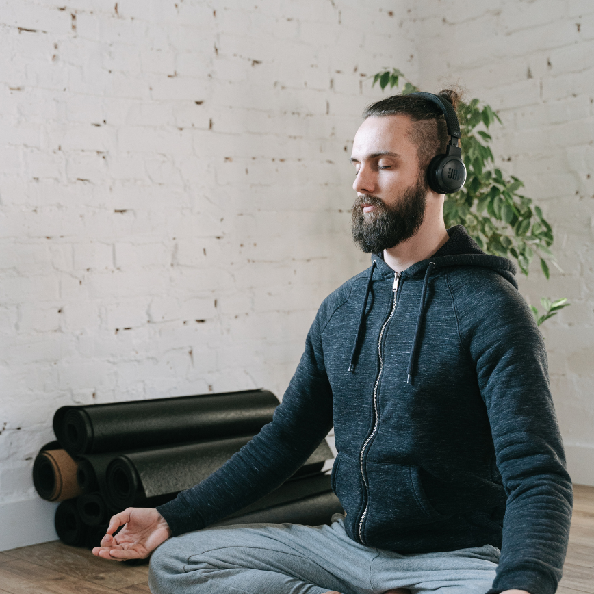 How to meditate for anxiety. A man wearing a headset meditating